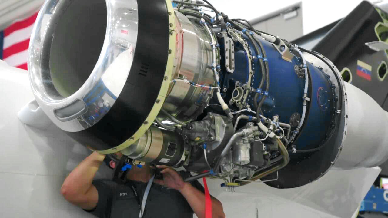 Technicial working on aircraft engine.